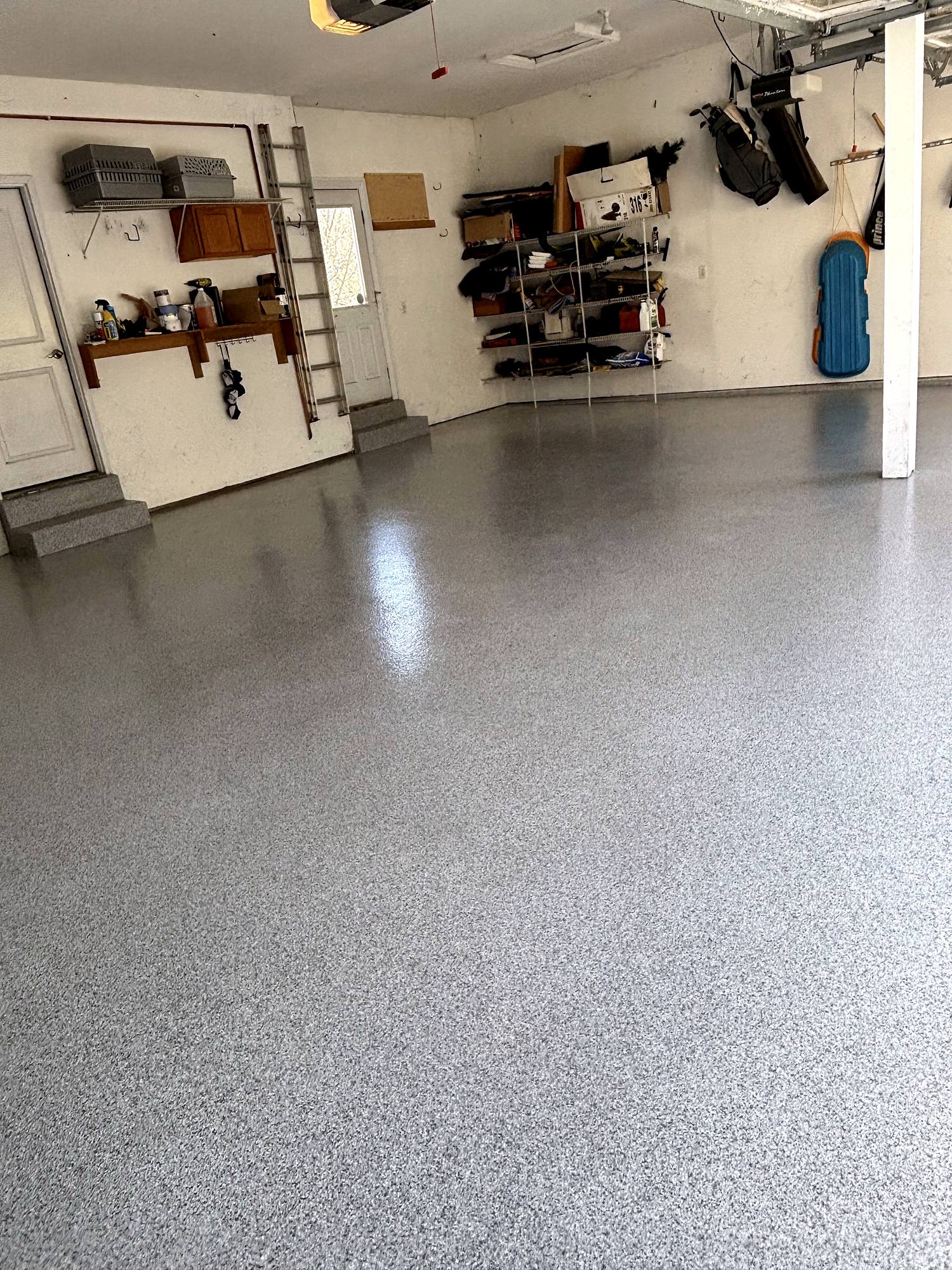 Finished flake epoxy floor with wall storage in view